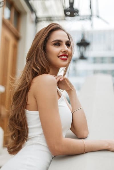 A beautiful woman looking out on a balcony